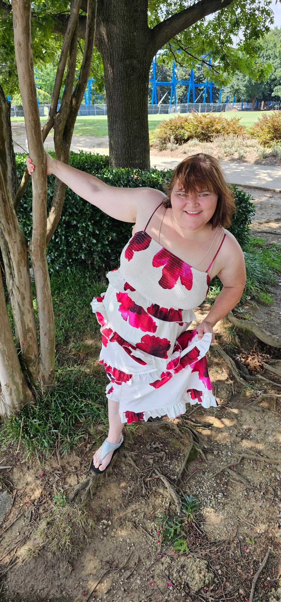 Myra twirling her dress by the tree