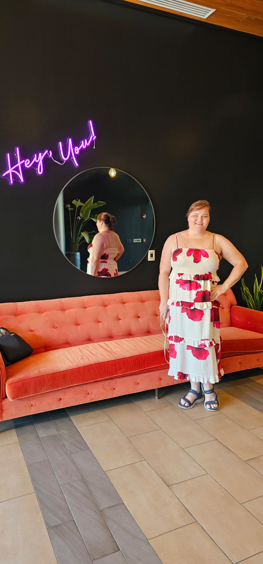 Myra by the 'Hey, You!' neon sign