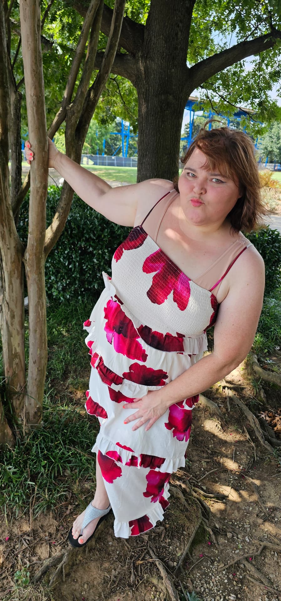 Myra making a funny face by the tree