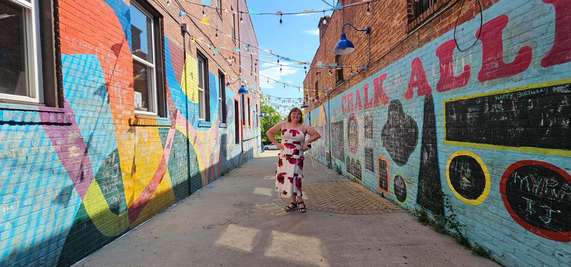 Myra in the middle of the mural-covered alley