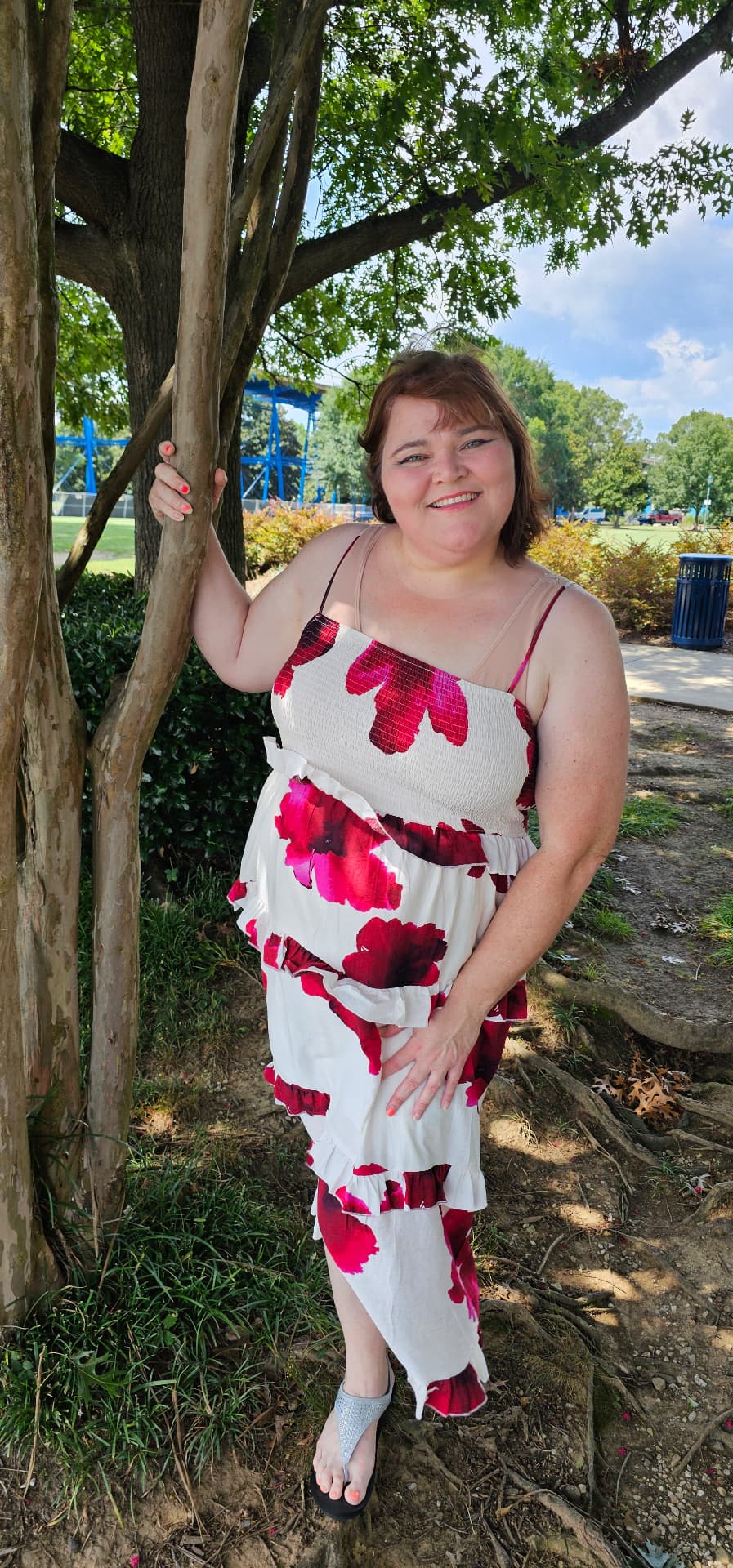 Myra leaning against a crepe myrtle, smiling